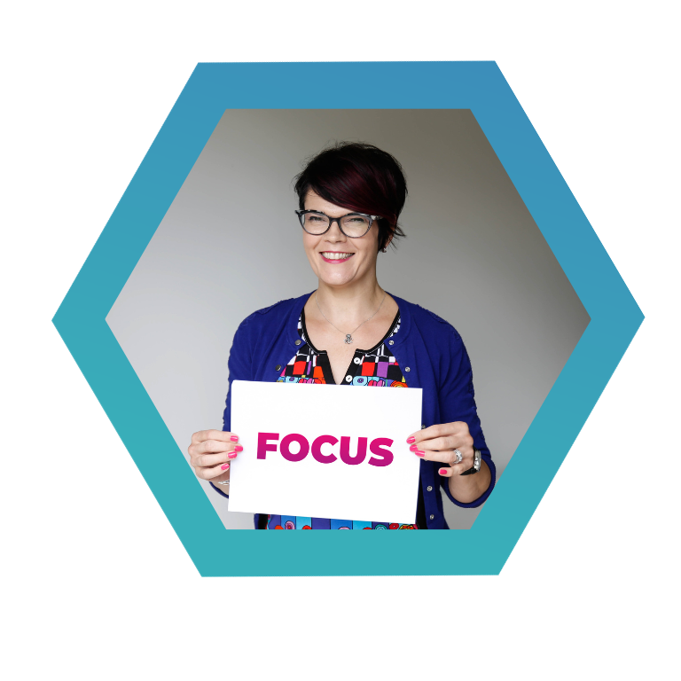 How to stay focused at work. Louise Pengilley holding a focus sign.